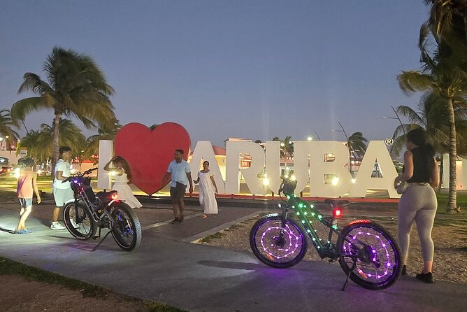 Semi-Private Christmas Edition Twilight Glow E-Bike Oranjestad - Oranjestad at night: colorful architecture, plazas, and the Blue Horses